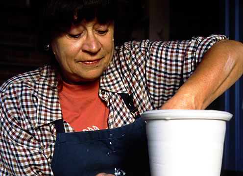 artist at work creating pottery for gallery