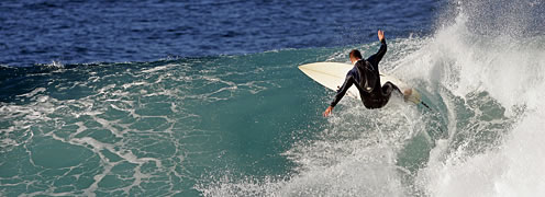 surfing catching a wave near Broulee south coast